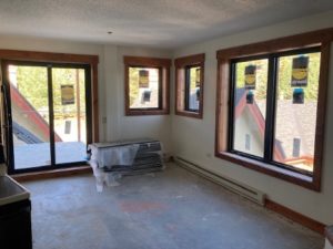 Unit under renovation highlights new windows and sliding door.