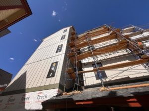 Picture of new siding and windows with scaffolding.